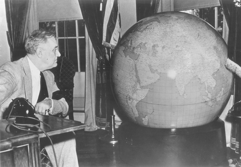 President Roosevelt Looking At An OSS Globe